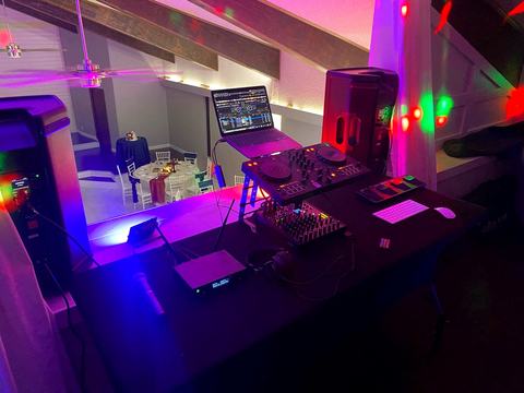 Wedding DJ setup with controller, mixer and dance floor lights