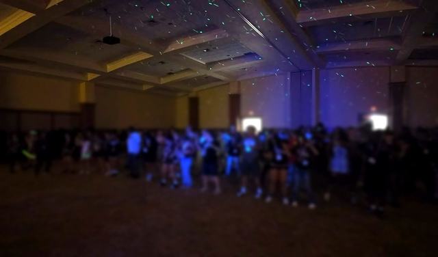 School dance crowd under ceiling lights