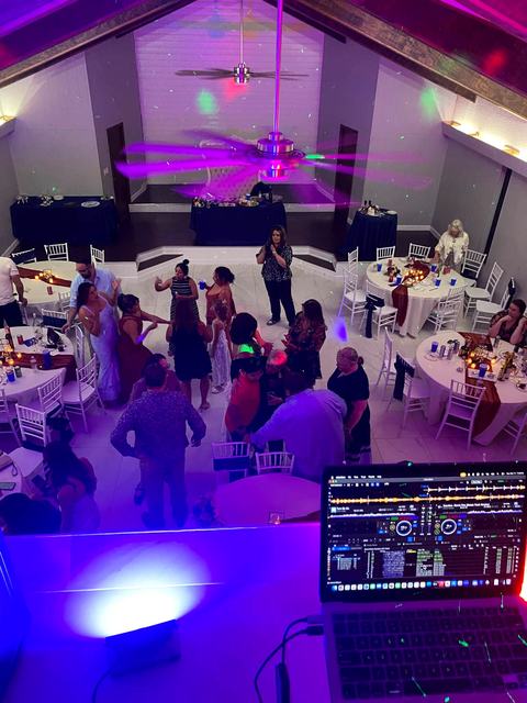 Wedding reception dance floor seen from the DJ booth under party lights